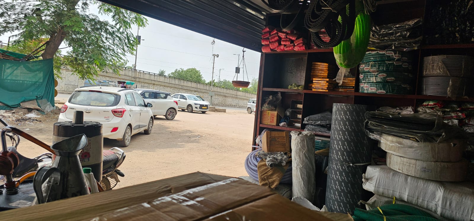 Inside the shop with stocked shelves, looking out to the roadside